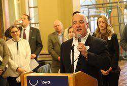 Bill Menner speaking at podium in rotunda